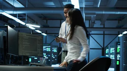 Team of Programmers in High Tech Data Center Troubleshooting Issues