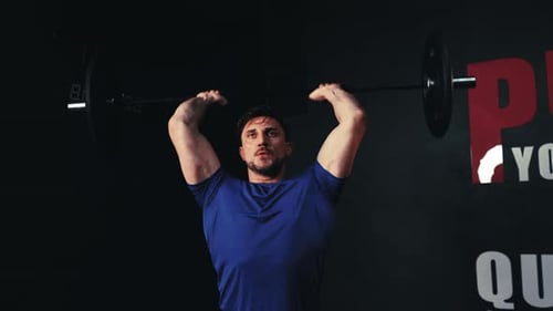 Man Lifting Barbell for Clean and Press Exercise