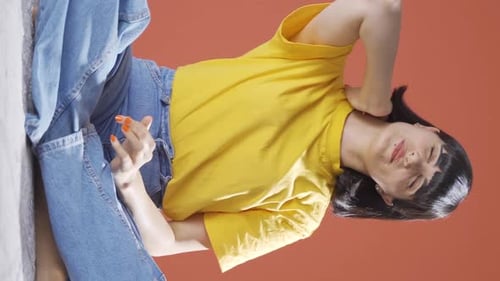 Stylish Woman Posing in Front of Orange Background