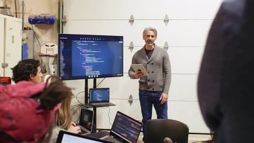 Adult Teaching Coding to Teens and Children
