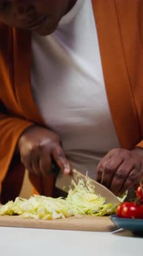 Black Food Blogger Cutting Iceberg Salad on the Cutting Board