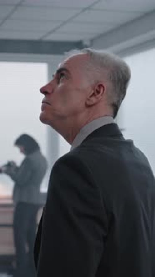 Office Robbery Case Medium Close Up of Male Detective Examining Crime Scene