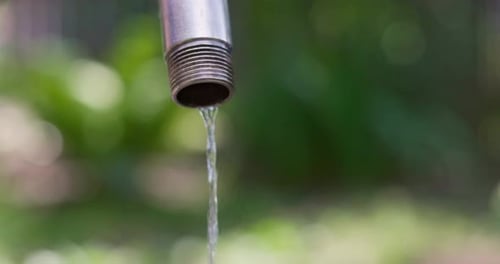 Water Pouring From Faucet Outdoors Wasting Water Shortage of Water Concept