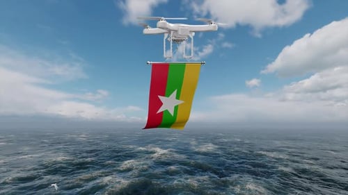 Drohne fliegt mit Flagge Myanmars über den Ozean
