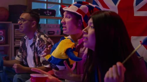 Friends Watching Match on TV and Cheering for UK Team