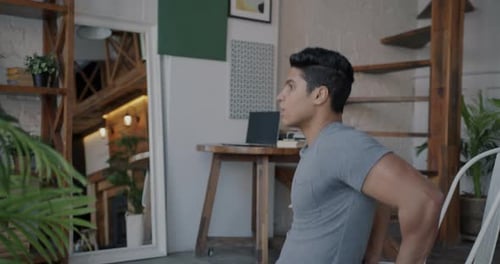 Man Doing Tricep Dips on Chair at Home