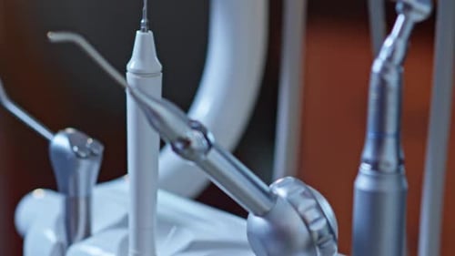 Dentist Taking Dental Drill Doctor Using Dental Tools in Modern Dentist Office
