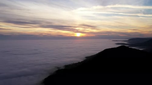 Aerial View Of Beautiful Sunset Over Sea of Clouds.