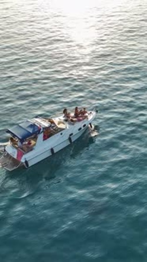 Friends enjoying yacht ride on a sunny summer day