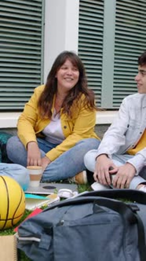 Group of Multiracial University Students Sitting Together at College Campus