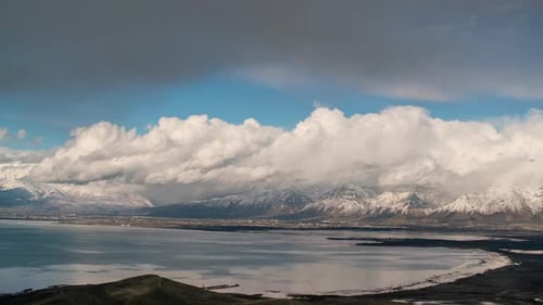 Timelapse of clouds moving over snowcapped Wasatch Mountains