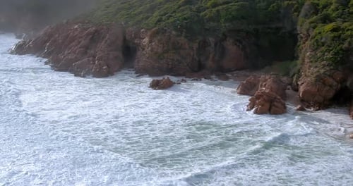 Drone, cliff and ocean, waves and nature landscape, travel and environment with coastline