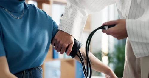 Blood pressure, consultation and doctor with woman in clinic for heart health, pulse or checkup