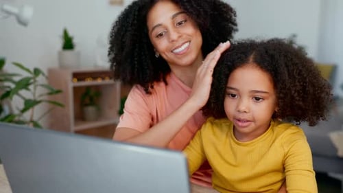 Mother and Child Looking at Laptop Together Indoors
