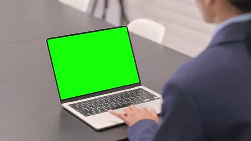 Businesswoman Working on Laptop with Green Chroma Key