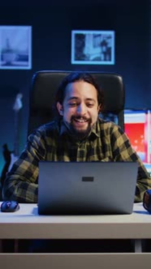 Person Talking During Laptop Conference Call at Night