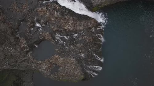 Aerial view of people jumping at Stjornarfoss waterfall, Iceland