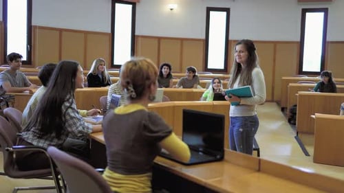 Young students listening a lesson inside university - School education concept
