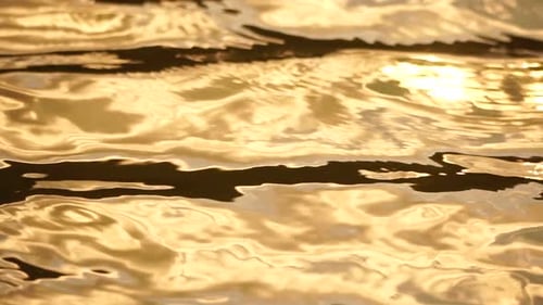 Sun Reflecting on Sparkling Sea Lake Water Surface Ocean at Sunset Sunrise Sunrays Flickering in