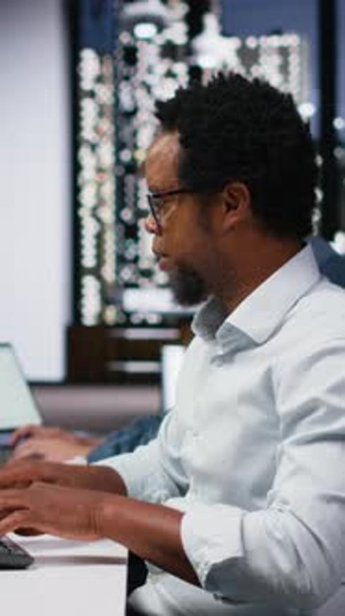 Vertical Video Tech Startup IT Specialist Developing AI Algorithms in Office Listening Music