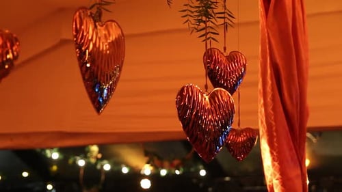several heart-shaped balloons hanging and spinning in a decorated saloon