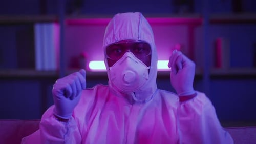 Adult in Hazmat Suit Points at Camera