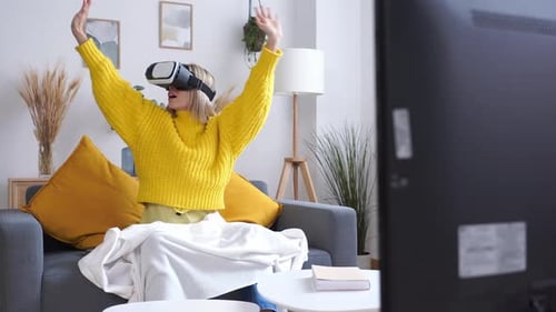 Woman Experiencing Virtual Reality with Headset at Home