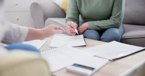 Financial Discussion Between Senior and Adult at Home