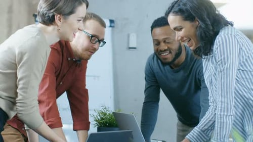 Diverse Group of Young Professionals Surround Conference Table and Collectively Try to Solve Proble