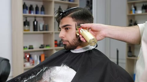 Young Man Gets Haircut at Barber Shop