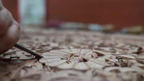 Close Up of Hand Carving Wood With Chisel
