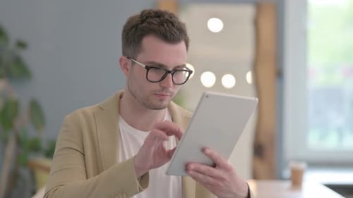 Portrait of Young Businessman using Tablet Computer