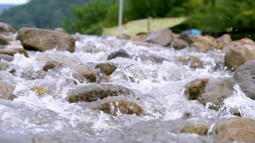 Clear stream running through stone boulders Abundant river flowing in slow motion. Wild mountain riv