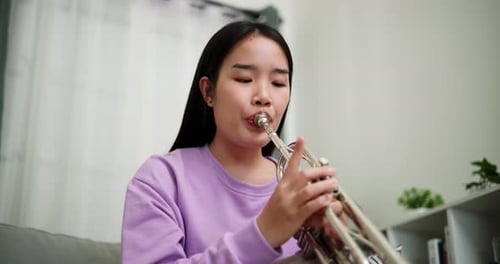 Young Person Plays Trumpet Indoors