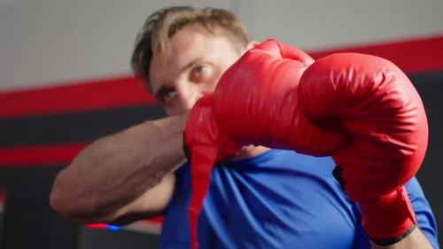 Caucasian sportsman wearing boxing glove prepare to exercise in gym.