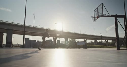 Basketball Player Practicing on City Court