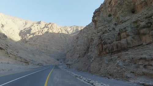 Shot of mountain range from car as camera moves through