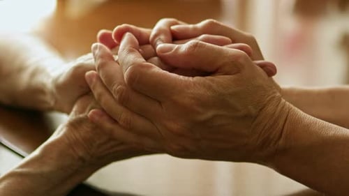 Close-Up of Adult Touching Hand of Senior