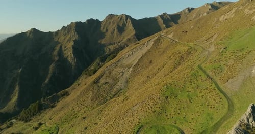 Isthmus Peak mountain trail leading up steep slope in New Zealand, sunrise