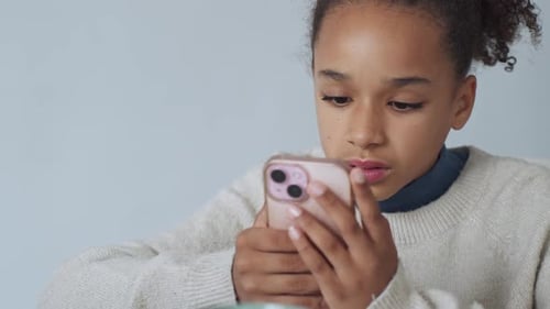 Concentrated Girl Using Smartphone Indoors