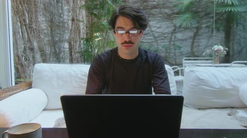 Freelancer Typing on Laptop during Workday in Home Office