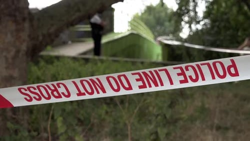 A London Metropolitan police officer stands guard at a taped off police cordon of a gun and knife cr