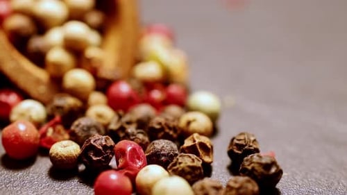 Mixed Peppercorns Spilling from Wooden Bowl Macro