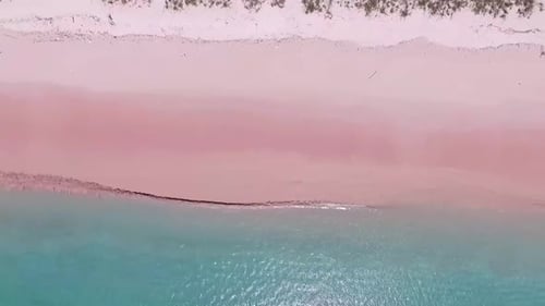 Pink Beach and Splash Wave in Komodo National Park, Indonesia cinematic with drone view aerial