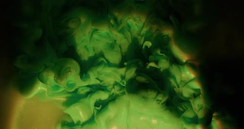 Green fluid swirls in gold liquid background abstract