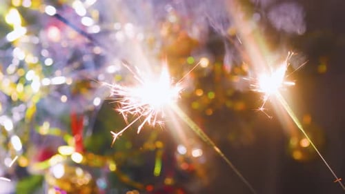 Sparkling Sparklers with Ornamented Christmas Tree Background