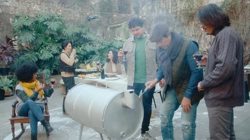 Friends Gather Outside, Enjoying Drinks and Conversation
