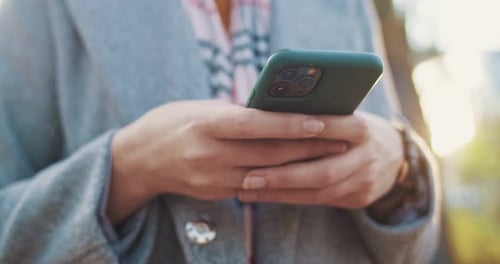 Close Up of Mobile Phone in Female Hands Woman Texting Message and Chatting on Smartphone Outdoor in