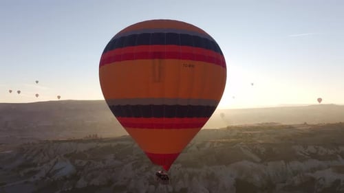 Goreme, Turkey - 01 December 2024: Aerial view of hot air balloons at sunrise, Turkey.