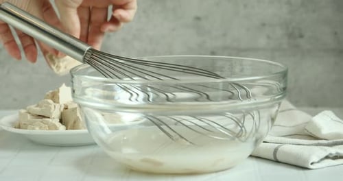 Mixing yeast for baking dough in clear bowl